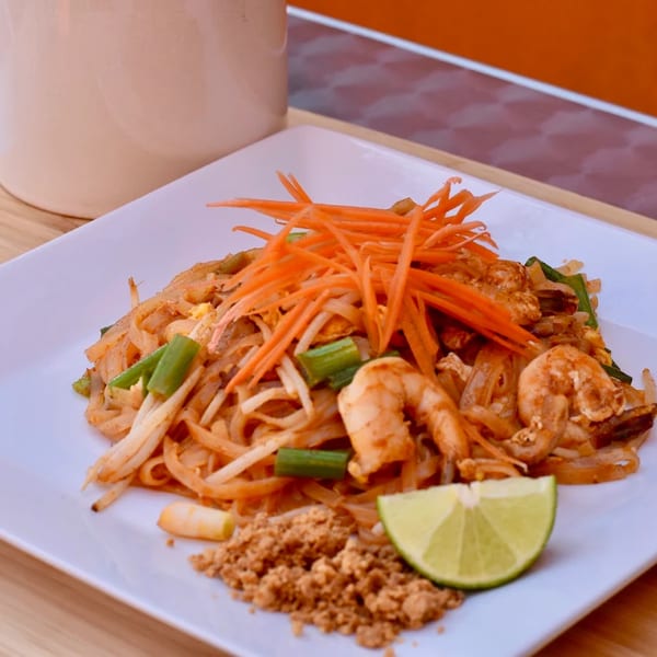 Shrimp pad thai with carrots, lime, and crushed peanuts