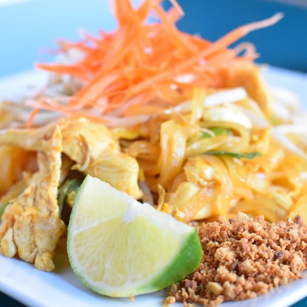 Chicken pad thai with lime and crushed peanuts
