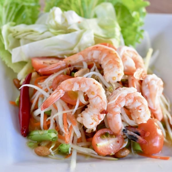 Som Tum, a Thai green papaya salad with shrimp, tomatoes, green beans, and peanuts.